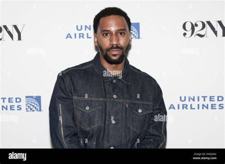 Siddiq Saunderson posing in a blue shirt.